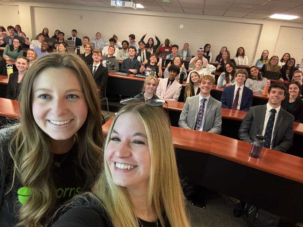 Ambassadors with a full lecture hall of students behind them