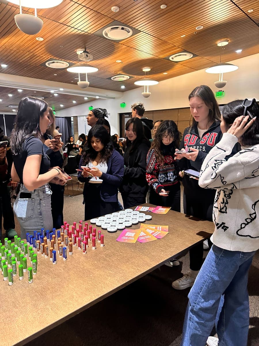 Students trying products at an indoor campus launch event