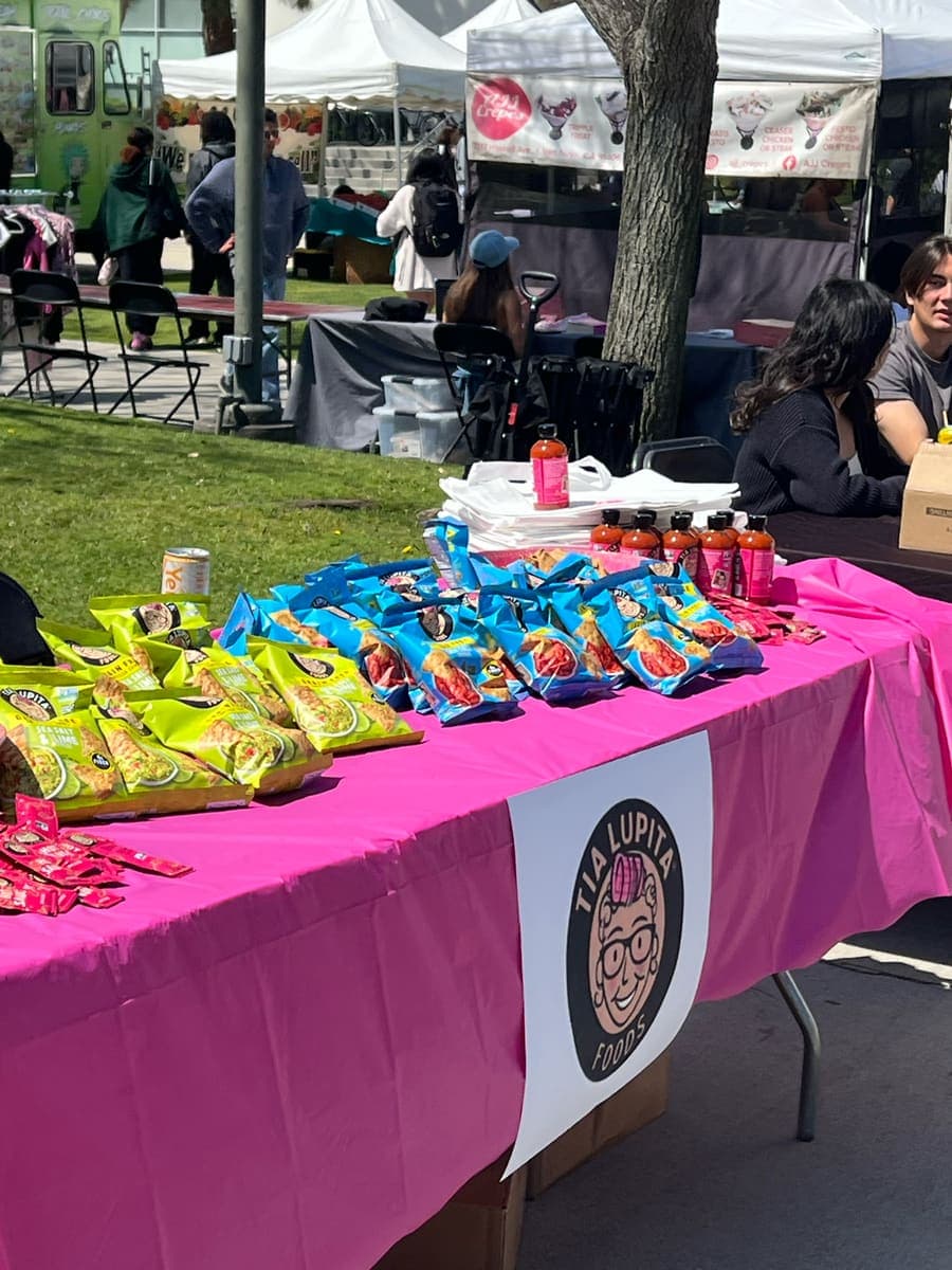 Product samples laid out on a branded table at a campus fair